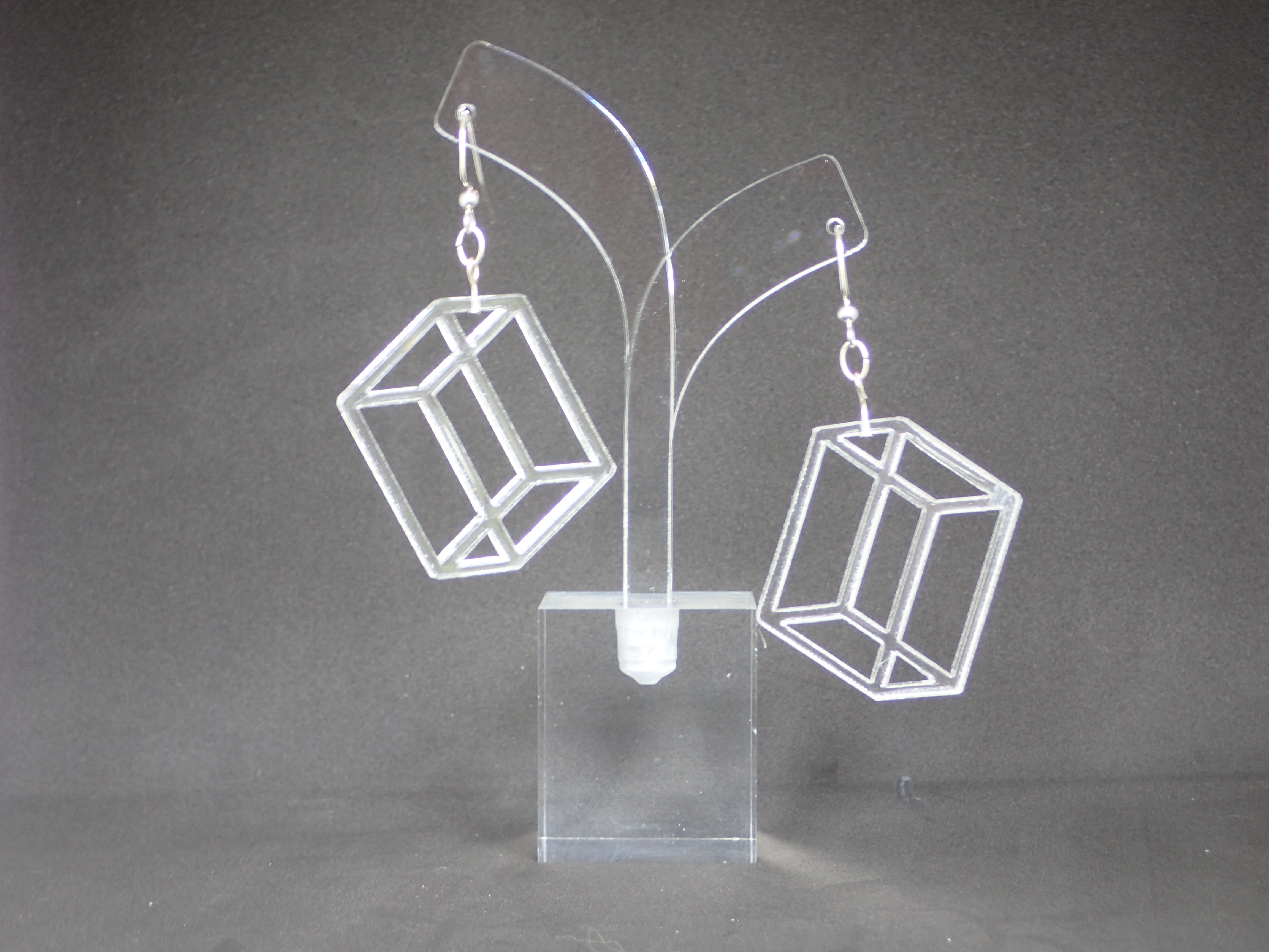 transparent acrylic earrings shaped like the three-dimensional frame of a rectangular crystal